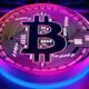 neon glowing bitcoin logo on a blue computer chip background