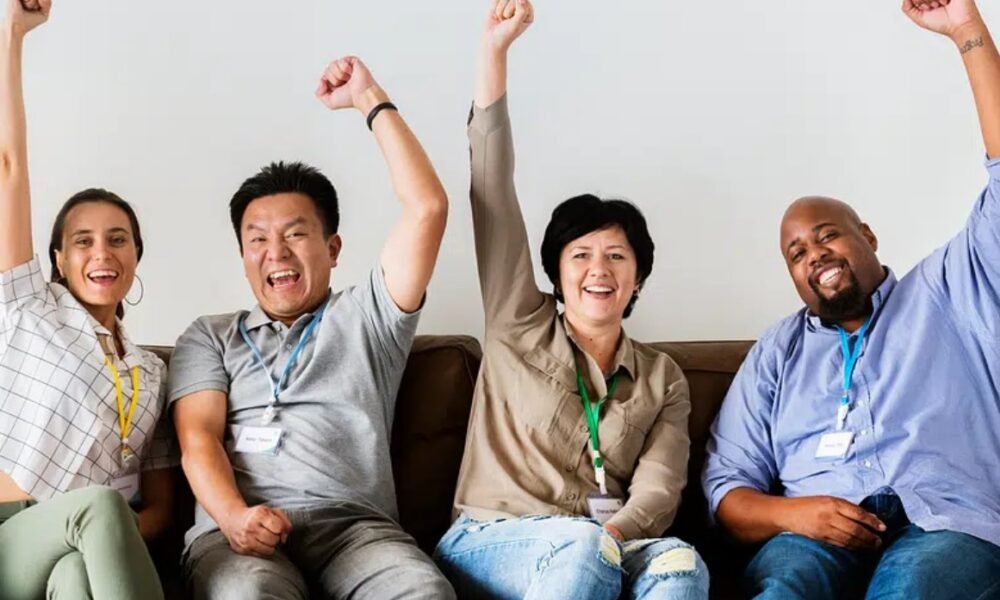investor cheering behind laptop office getty images
