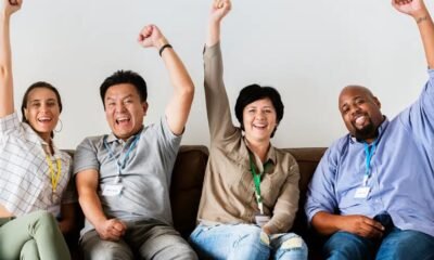 investor cheering behind laptop office getty images