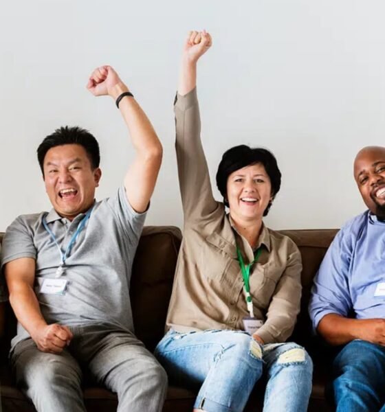 investor cheering behind laptop office getty images