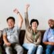 investor cheering behind laptop office getty images
