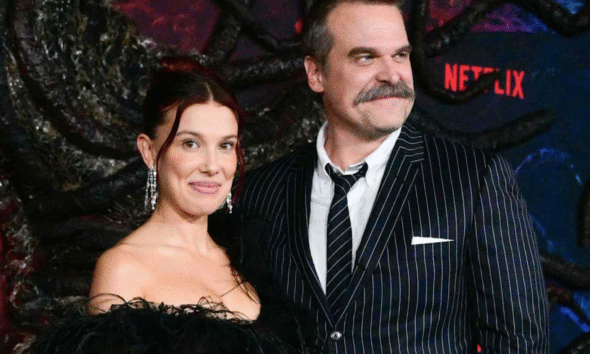 Millie Bobby Brown and David Harbour hug